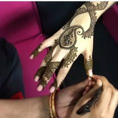 two hands with henna designs on them