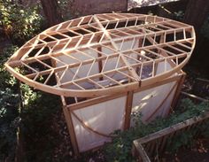 a wooden structure sitting in the middle of a forest