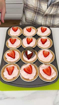 cupcakes with pink frosting and strawberries arranged in the shape of hearts