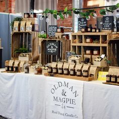 the table is covered with old - fashioned items for sale at an outdoor market stall