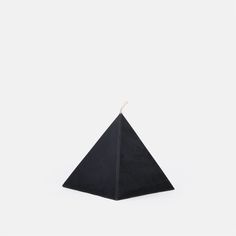 a black triangle shaped object on a white background