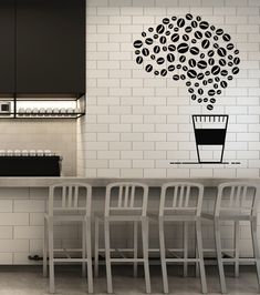 a kitchen with white brick walls and black accents on the wall is decorated with coffee beans