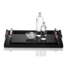 a black tray with two bottles on it