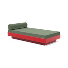 a green and red daybed sitting on top of a white floor next to a roll of paper