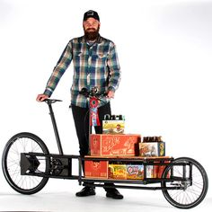 a man standing next to a bike with beer on it