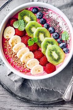 a bowl filled with fruit and nuts on top of a table