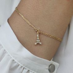 "PERFECT CHRISTMAS GIFT FOR LADIES You are getting a dainty, tiny Paris Eiffel Tower Gold Tone bracelet inlayed with Swarovski crystals. Pendant size is 5/16\" wide X 10/16\" high (9mm X 17mm) Crystal Color: Crystal Clear The bracelet measures 7\" long (17.7cm) with 2\" extension chain (5cm). Prices are in US$. For shipping policies and other important information, click on \"profile\" on the right. See an item that you like but has already been sold? Contact me to see if I have more! Thank you Charming Gold Charm Bracelet As Gift, Elegant Gold Bracelets For Holiday, Elegant Gold Bracelets For Holidays, Elegant Gold Charm Bracelet Gift, Gold Bracelets For Holiday Gifts, Elegant Gold Charm Bracelet For Gifting, Holiday Adjustable Gold Jewelry, Gold Bracelet Jewelry For Holidays, Adjustable Gold Holiday Jewelry