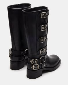 The ROCKY knee boot features the wide profile of an engineer boot with harness and buckle hardware adding an industrial edge and giving the design an adjustable fit. Block heel engineer boot Slip-on style Top gore with 4 adjustable buckle straps 2 inch heel height Size 6 measurements: 14.5 inch shaft circumference, 12.5 inch shaft height Size 8 measurements: 15 inch shaft circumference, 13 inch shaft height Size 10 measurements: 16 inch shaft circumference, 13.5 inch shaft height Leather upper m Class Of The Titans, Platform Slip Ons, Black Buckle Boots, Boots Steve Madden, Rocky Boots, Black Winter Boots, Summer Wardrobe Staples, Engineer Boots, Shoes To Buy