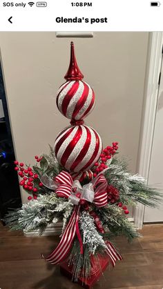 a red and white striped christmas tree in a vase