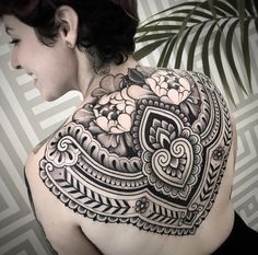 a woman with a tattoo on her back