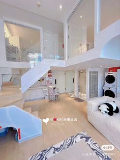 a living room filled with lots of furniture and white walls on top of wooden floors