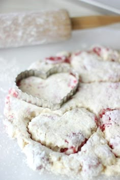 heart shaped cookies sitting on top of a white counter