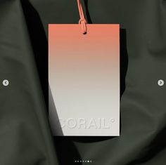 an orange and white tag hanging from a green jacket