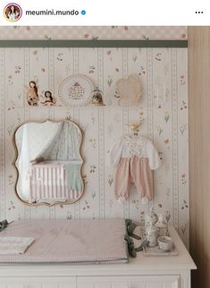 a baby's room is decorated in pastel colors and floral wallpapers