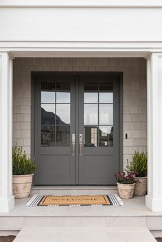 an instagram page with two doors and potted plants on the front porch,