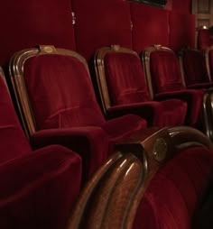 rows of red velvet seats in an empty theater or movie theatre with no people inside