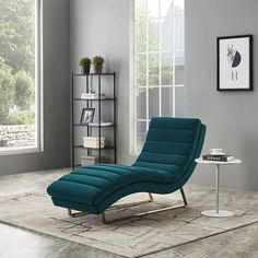 a blue chaise lounge chair sitting on top of a rug in a living room