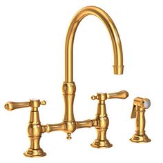 a golden faucet with two handles and nozzles on the side, in front of a white background