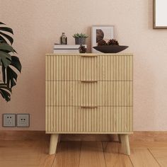 a wooden dresser sitting next to a potted plant on top of a hard wood floor