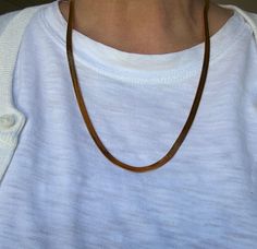 This classic 1990s Monet herringbone necklace measures 22 inches and is gold-plated with a sleek, shiny finish. It is in excellent condition, complete with its original hang tag. The herringbone design adds a timeless and sophisticated touch, making it a versatile piece for both casual and formal wear. Monet Jewelry, founded in 1937, is known for its high-quality costume jewelry that mimics fine jewelry trends. The brand became renowned for its elegant and affordable designs, often plated in gol Herringbone Design, Herringbone Chain, Herringbone Necklace, Monet Jewelry, Jewelry Trends, Formal Wear, Gold And Silver, Herringbone, Chains Necklace