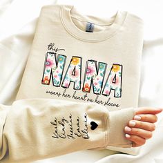 Custom Sweatshirt and Hoodie for Nana, Christmas Gift for Nana, Nana Sweatshirt, Nana Sweatshirt with Grandkids Name on Sleeve, Nana Gift This shirt has a hand pressed design. It has a very soft touch that you will feel comfortable for a long day. HOW TO ORDER ** Check and Review all Photos. ** Select your item's Size and Color from drop down menus. ** Choose the Quantity you want. ** Provide personalization in personalization box if offered.(name, print color etc.) ** Click ADD TO CART. And, yo Gifts For Nana, Nana Christmas, Nana Sweatshirt, Nana Christmas Gifts, Heat Press Printing, Name Print, Stitch Shirt, Nana Gifts, Custom Sweatshirts