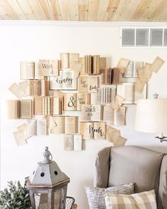 a living room with lots of books on the wall and a lamp next to it