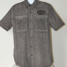 Nwt Affliction Premium Black Label Live Fast Buttons Down Shirt 100% Guaranteed Authentic Size Large Color Dark Short Sleeves Full Length Buttons Placket Chest Flap Pockets Embroidered Patch On Chest Huge Graphic With Embroidery On Back Regular Fit Slightly Rounded Hem 100% Cotton Spare Buttons Attached To Care Instructions Measurements Size Armpit To Armpit Length L 23 ½ In 32 In Rugged Cotton Pre-washed Shirt, Rugged Pre-washed Cotton Shirt, Distressed Fitted Casual Shirt, Fitted Distressed Casual Shirt, Casual Fitted Distressed Shirt, Distressed Cotton Button-up Shirt, Button-up Washed Tops For Streetwear, Rugged Relaxed Fit Top With Button Closure, Distressed Collared Cotton Top