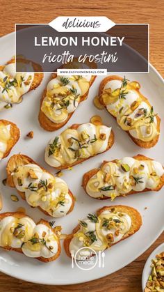 lemon honey ricotta crostini on a white plate with other appetizers