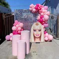 a barbie doll is surrounded by balloons and candles