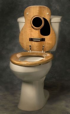 a toilet with a wooden seat and cover