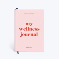 a pink notebook with the words my wellness journal written in red and black on it