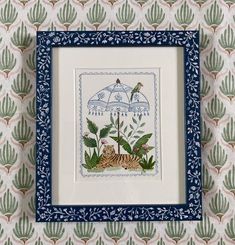 an embroidered picture frame with a tiger and bird in the jungle on it's side