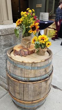 a wooden barrel with some flowers in it