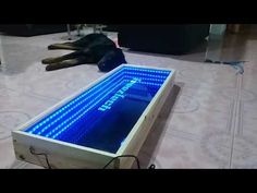 a large wooden table sitting on top of a tiled floor next to a dead animal