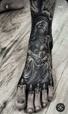 a foot with an image of the virgin mary and baby jesus on it