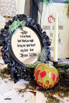 an ornate frame with a poem on it next to a candle and some decorations in the background