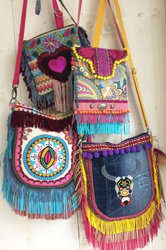 three colorful purses hanging on the wall