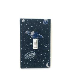 a light switch cover with space and stars on it