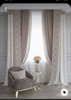 a living room with two chairs and a table in front of a window that has drapes on it