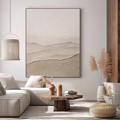 a living room with white furniture and art on the wall above it is an abstract painting