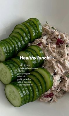 cucumber slices and tuna salad in a white bowl with the words healthy lunch