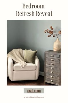 a white chair sitting next to a wooden dresser