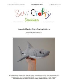 a hand holding up a stuffed shark sewing pattern