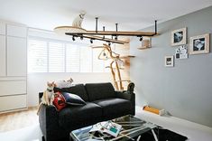 a cat sitting on top of a couch in a living room