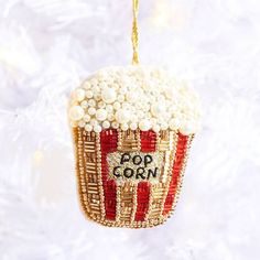 a popcorn ornament hanging from a christmas tree