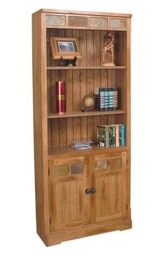 a wooden bookcase with two doors and three shelves on each side, holding books