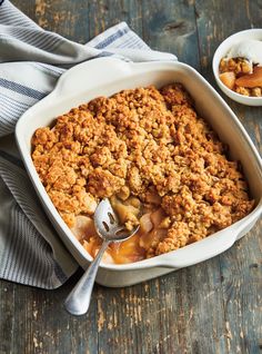 a casserole dish with apples and crumbled topping