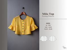 a yellow blouse with ruffles and buttons on the front is hanging up against a gray wall