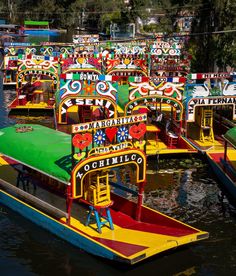 many colorful boats are floating on the water