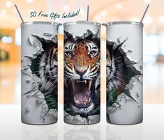 two stainless steel tumblers with an image of a tiger breaking through the wall and showing its teeth